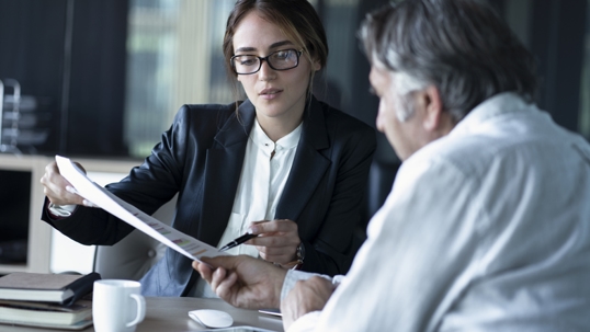 person looking over documents with lawyer