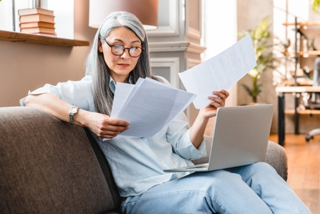 woman reviewing documents at home