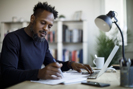 man reviewing documents at home