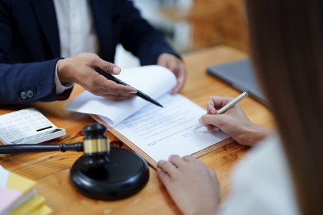 person signing document in lawyer's office