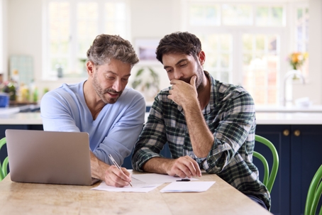 same-sex couple looking at documents