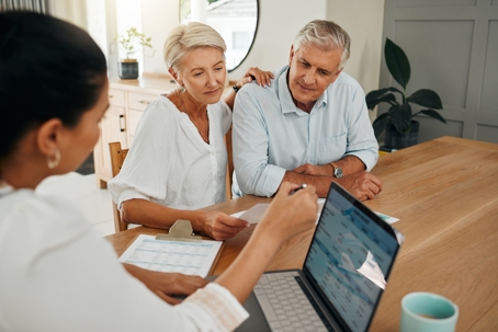 Old People with Younger Woman Looking at Computer