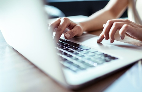 person typing on a laptop