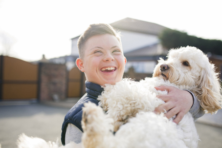 person with special needs holding a dog